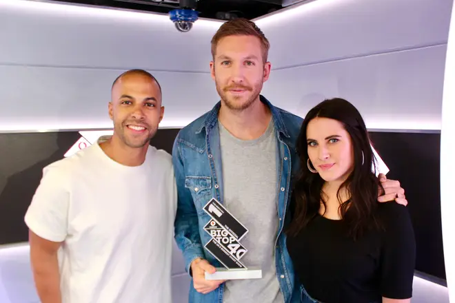 Calvin Harris with the Official Big Top 40 from Global Number 1 trophy